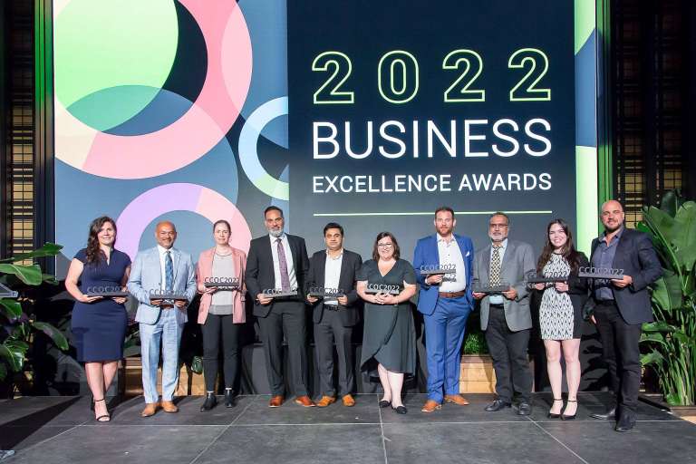 Staff from the Cambridge Chamber of Commerce holding awards at a ceremony