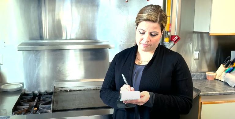 Public Health Inspector Bernadette Moussa inspects a commercial kitchen for the Region of Waterloo.