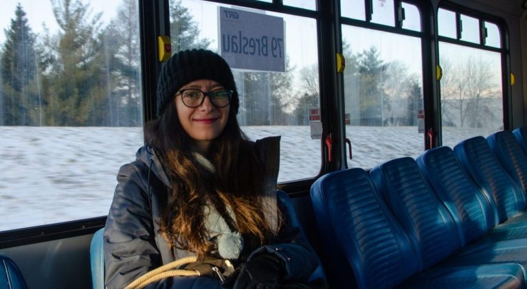 A woman sits in a Grand River Transit bus.