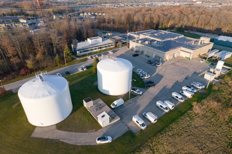 Overhead view of large white water storage tanks and other buildings at the Mannheim Water Treatment Plant.