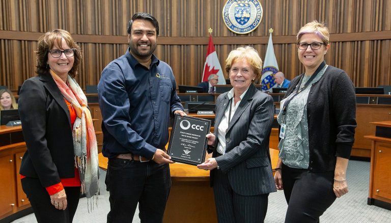 Regional Chair Karen Redman presents an award plaque in the Region's council chambers.