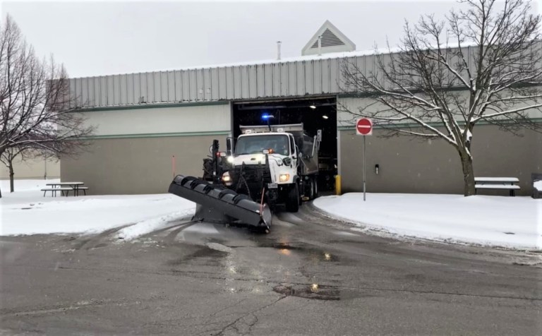 A Region of Waterloo snow plow leaving a maintenance facility.