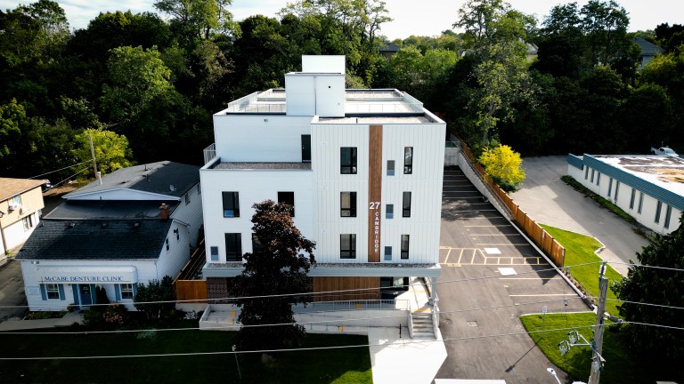 Aerial photo of a new four-storey apartment building.