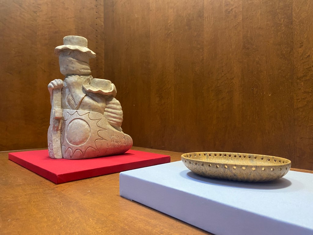 Soapstone carvings in a display case.