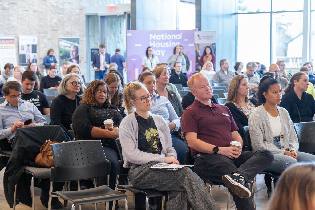 An audience sits to watch National Housing Day.