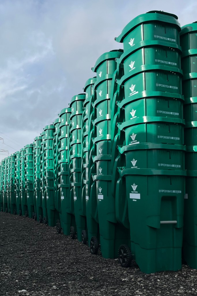 Hundreds of new green organics carts stacked and ready for delivery.
