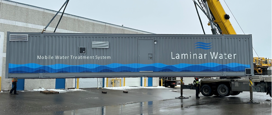 A large rectangular filtration unit is moved into place at the Mannheim Treatment Plant.