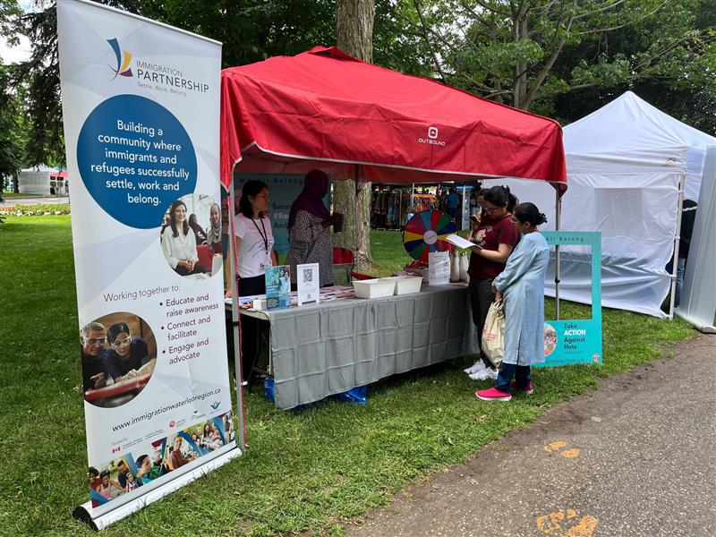 An Immigration Partnership information booth at a community event.