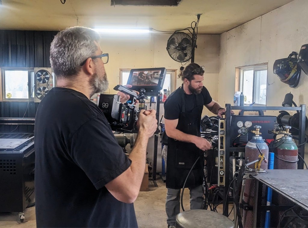 Filmmaker Alvin Witcher shoots a scene in a workshop environment.