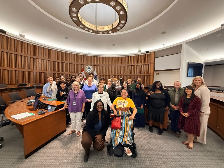 Participants in the YouthForce program pose with Regional Council members in the council chambers.
